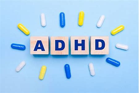 Bold letters spelling ADHD on a blue background with little capsules around it Buy Ozempic Online
