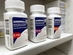 adderall for sale online A bottle of Adderall tablets with a subtle medical background, representing ADHD prescription medication for focus and cognitive support.