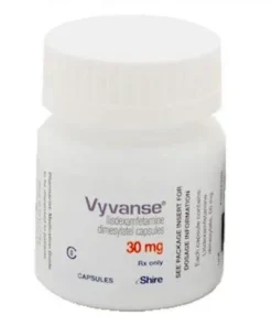 A bottle of Vyvanse capsules with a subtle medical background, representing ADHD prescription medication for focus and cognitive support.