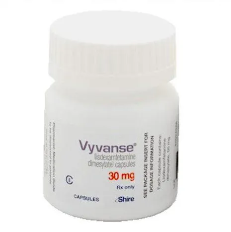 A bottle of Vyvanse capsules with a subtle medical background, representing ADHD prescription medication for focus and cognitive support.